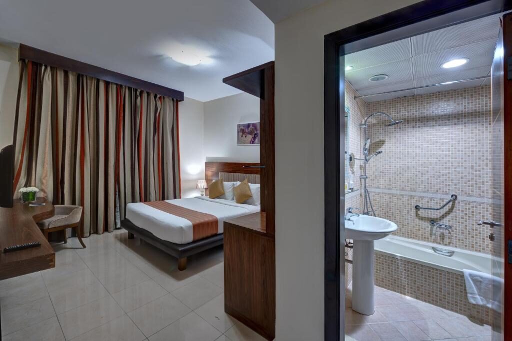 Room and bathroom at Aryana Hotel Sharjah